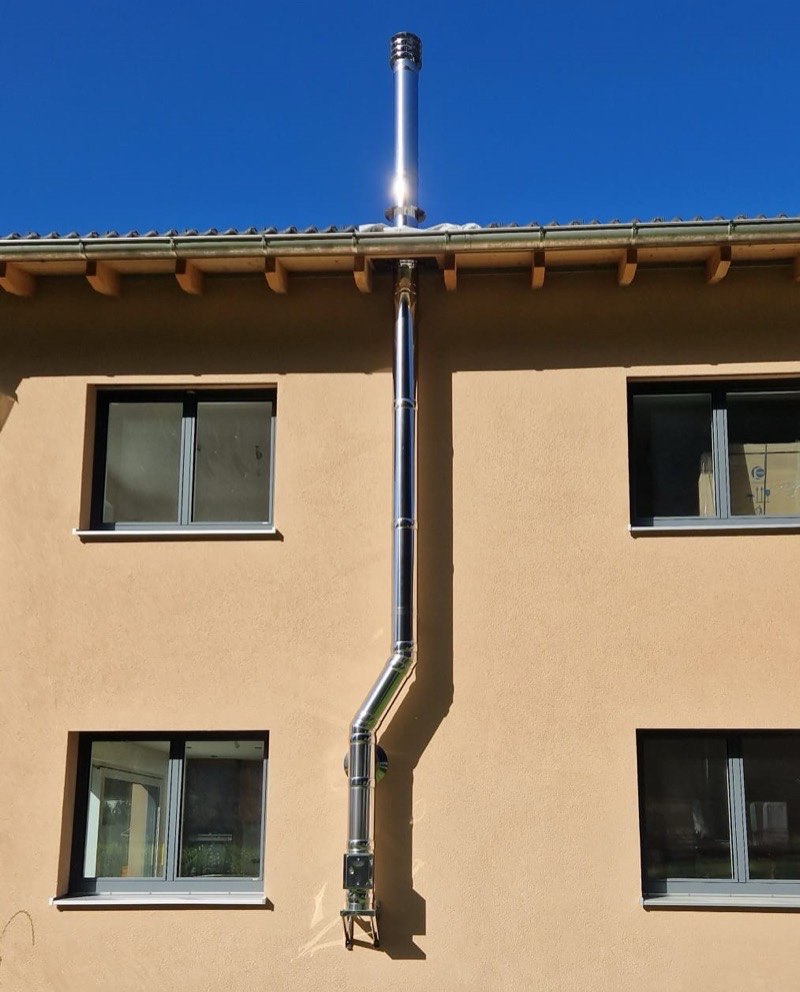 Edelstahlkamin von ALBÖ, außen an der Fassade bis über das Dach geführt